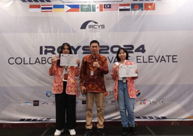 
					Kepala SMAN 1 Palu, Dahlan M. Saleh, saat foto bersama dengan dua siswa yang raih prestasi internasional tersebut. (FOTO: IST)