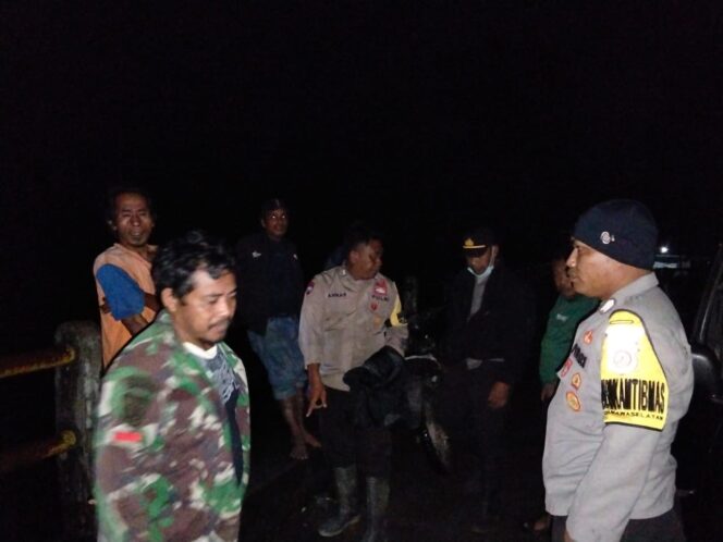 
					Petugas kepolisian, aparat desa, dan warga setempat berkumpul di sekitar lokasi kejadian untuk berkoordinasi dalam upaya pencarian lansia yang diduga hilang terseret arus sungai di Desa Lumbumamara, Kecamatan Banawa Selatan, Kabupaten Donggala, Senin malam (07/07/25). FOTO: istimewa