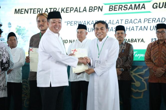 
					Menteri Agraria dan Tata Ruang/Kepala BPN, Nusron Wahid (kiri), menyerahkan sertipikat tanah wakaf dan rumah ibadah kepada perwakilan penerima dalam kegiatan penyerahan sertipikat di Masjid Nasional Al-Akbar Surabaya, Sabtu (13/12/25). FOTO: istimewa